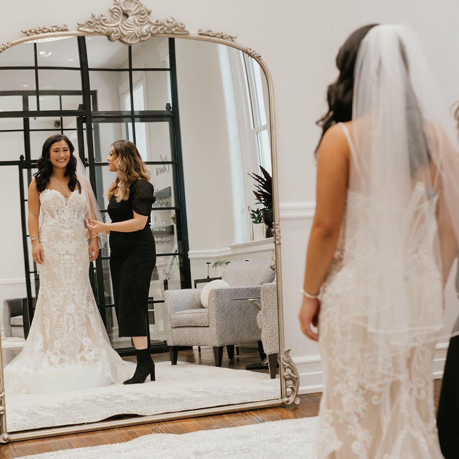 A woman trying on a dress in a wedding dress store in Louisville, KY